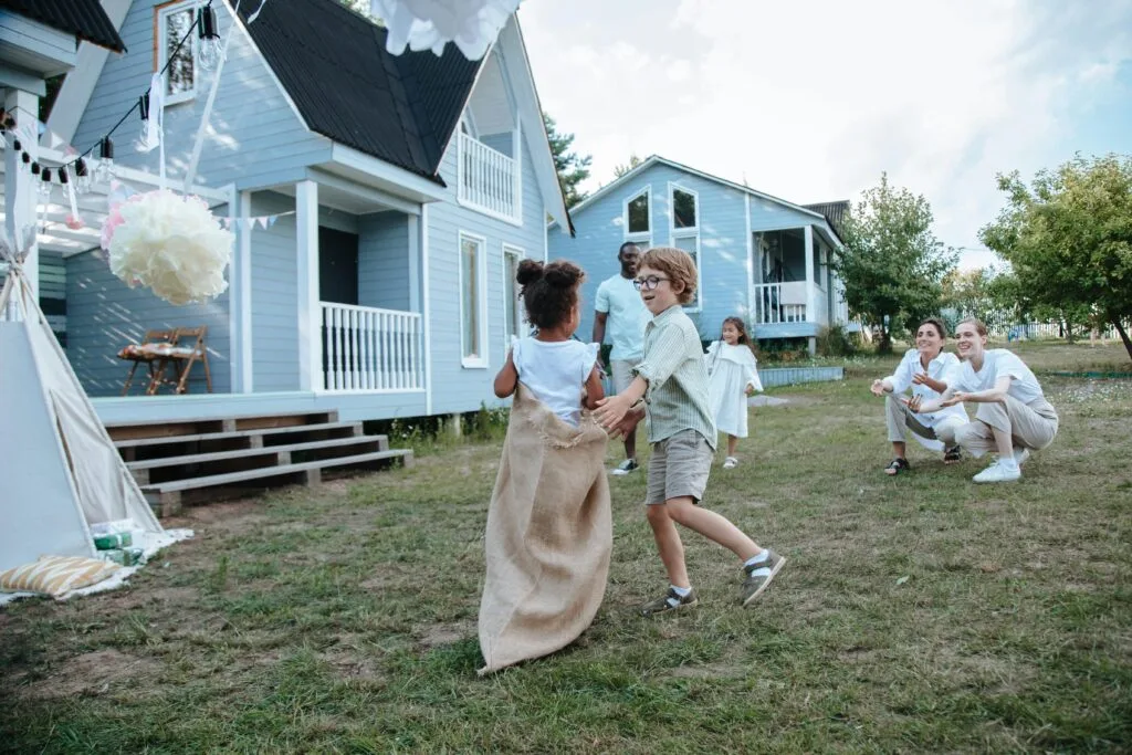 A man playing sack race game with his family